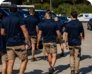 Plumbers walking to their service vans on a Prospect job